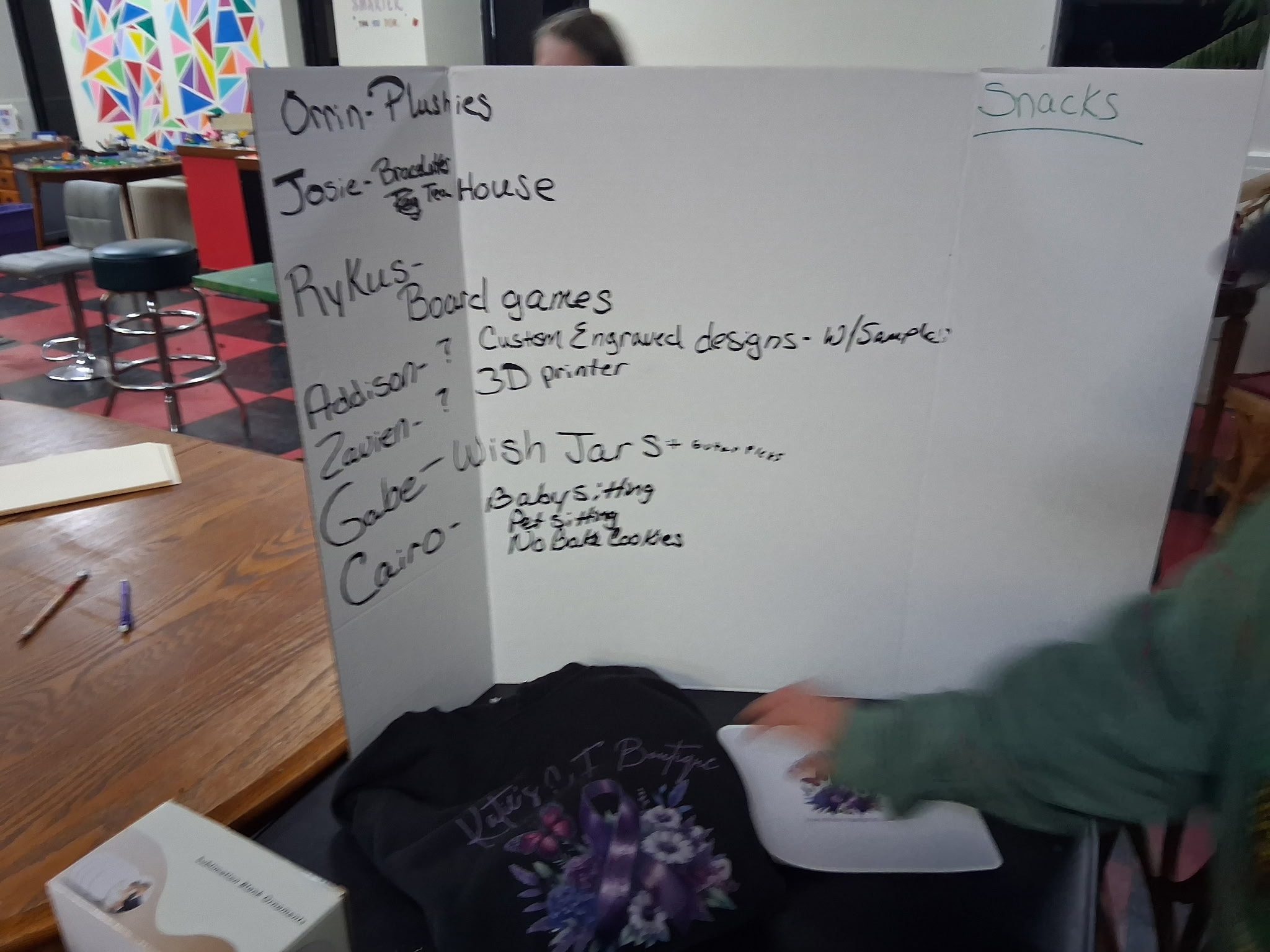 The idea board from the club's first session, listing business ideas including plushies, a tea house, board games, custom engraved designs with a 3D printer, wish jars, babysitting, pet sitting, and no-bake cookies